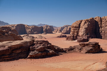 Fototapeta na wymiar In the Wadi Rum desert of Jordan, a photo captures the rugged beauty of rock formations and sandy dunes.
