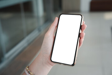 Woman holding and using mobile phone with blank desktop screen. Mockup display smartphone.
