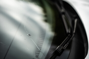 window broken by a stone in the car - insurance - road accident - broken glass - obrazy, fototapety, plakaty