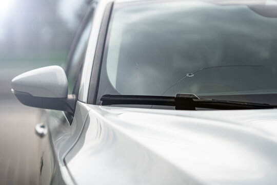 window broken by a stone in the car - insurance - road accident - broken glass