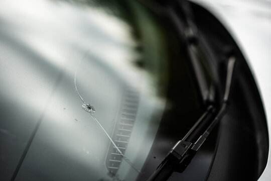 window broken by a stone in the car - insurance - road accident - broken glass