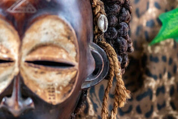 Wooden tribal African mask from Uganda, for family or personal protection, made of local wood, ropes and seashells as hair decoration