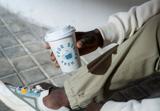 Mockup of man holding customizable takeaway cup