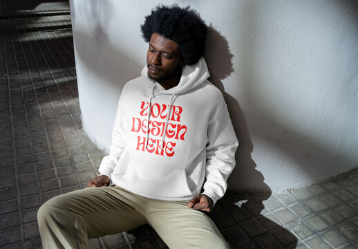 Mockup of man wearing customizable hoodie, resting