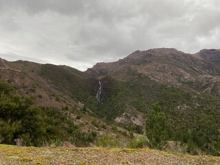 waterfall in distant view on mountainside