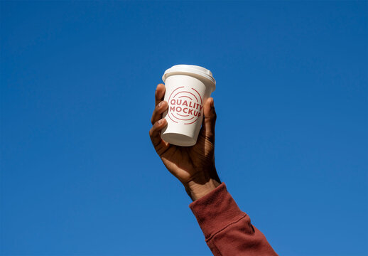Mockup of man holding customizable cup, blue background