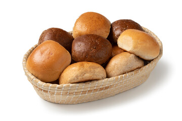Basket with a variation of white and brown buns of bread close up isolated on white background