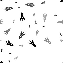 Seamless vector pattern with rockets, creating a creative monochrome background with rotated elements. Vector illustration on white background
