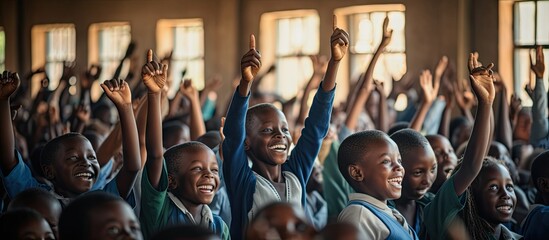 Fototapeta premium Happy students at a school in Uganda Africa Students raising their hands. Creative Banner. Copyspace image