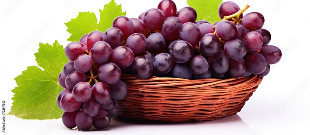 Poster grapes with leaves in wicker basket isolated on white background. creative banner. copyspace image