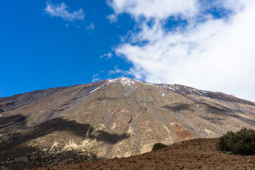 Amazing volcano Del Teide with a wide angle view and white clouds,  beautiful shadows and blue sky. Tenerife, Canary Islands, Spain. - 722918589