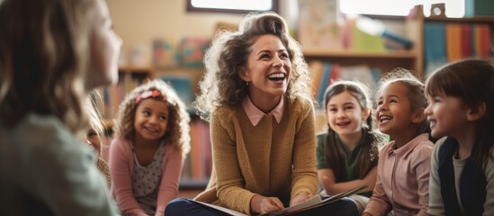 Fototapeta premium Happy primary school teacher holding a lesson to group of her students in the classroom. Creative Banner. Copyspace image