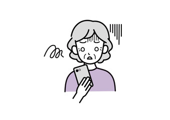 スマホを見て落ち込んでいるシニア女性