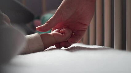 Woman gently touch and hold sleeping newborn baby hand, mother love and care - Powered by Adobe