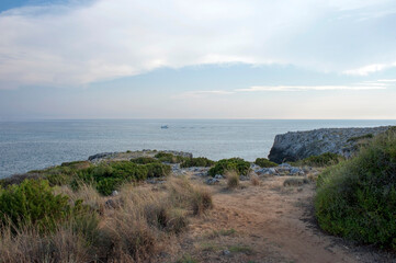 View of the horizon from the clifftop at the beginning of the evening with the first afterglow of the sunset. Marina di Camerota, Italy.