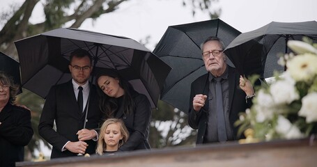 Death, funeral and umbrella, people at coffin for service in graveyard in respect, mourning and...