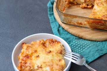Homemade vegan Lasagne with soy meat and vegan cheese on a white plate
