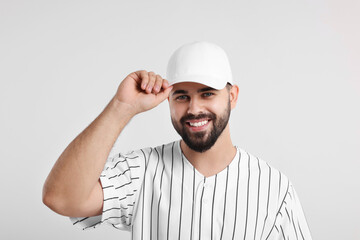 Man in stylish baseball cap on white background