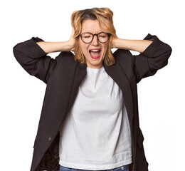 Caucasian woman in black business suit covering ears with hands trying not to hear too loud sound.