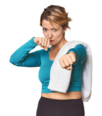 Caucasian woman in sportswear with towel throwing a punch, anger, fighting due to an argument, boxing.