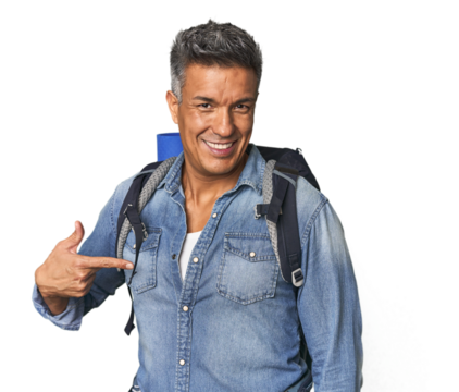 Hispanic hiker with backpack and flask person pointing by hand to a shirt copy space, proud and confident