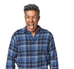 Fototapeta premium Middle-aged Latino man funny and friendly sticking out tongue.