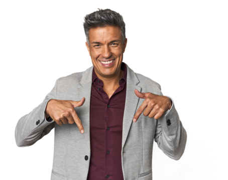 Middle-aged Latino man points down with fingers, positive feeling.