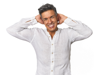 Middle-aged Latino man stretching arms, relaxed position.