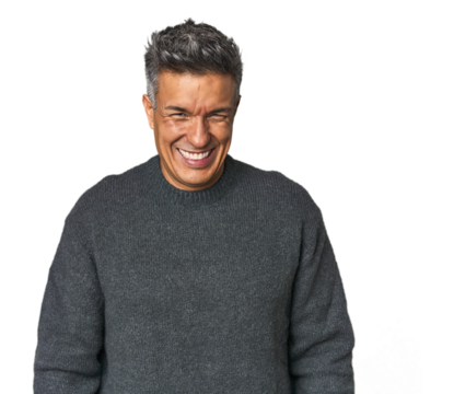 Middle-aged Latino man laughs and closes eyes, feels relaxed and happy. - Powered by Adobe