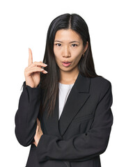 Young Chinese woman in business suit having some great idea, concept of creativity.