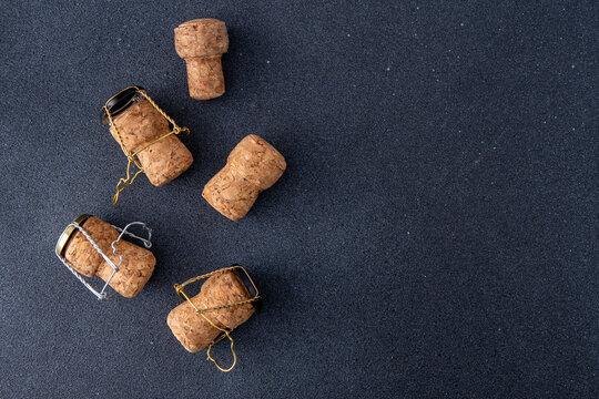 Champagne corks and metal mesh. Dark wine background.