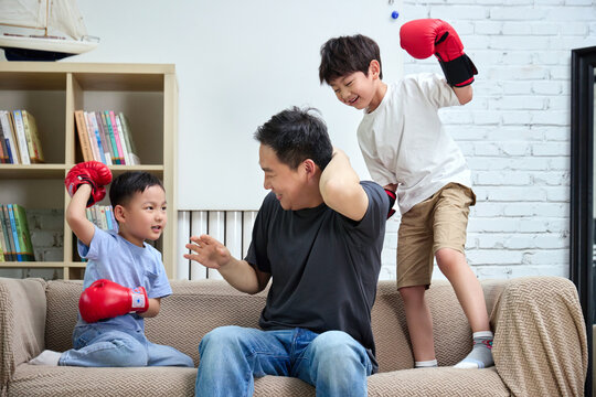 Father and son wearing boxing gloves