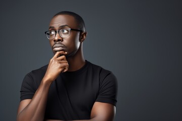 Black History Month, Thoughtful african american guy thinking, try solve problem on grey studio background