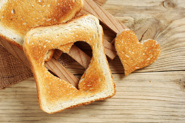 Toasted bread with cut out heart-shaped slice