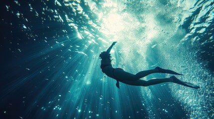 a woman free diving towards light in an underwater setting, freedom, exploration, and connection with nature, adventure