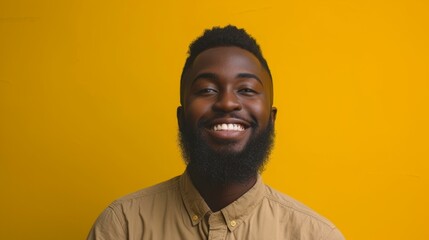Obraz premium Happy African American man with beard wearing brown shirt