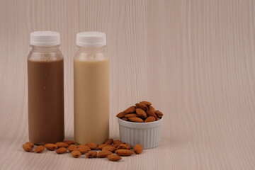 Chocolate and vanilla almond milk in a plastic bottle. made from almonds, water and sugar. suitable for vegetarians and vegans as well as people who are allergic to cow's milk. susu almond vanila. 