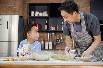 Father and son baking together
