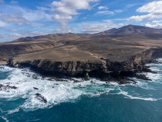 Fototapeta na wymiar West coast of Fuerteventura island. View on blue water and black caves of Ajuy village, Canary islands, Spain.