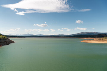 Green reservoir lake on a summer day. Aguilar de Campoo, Spain
