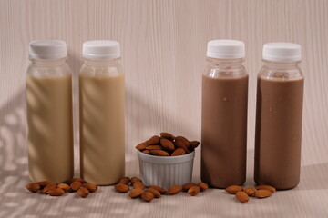 Chocolate and vanilla almond milk in a plastic bottle. made from almonds, water and sugar. suitable for vegetarians and vegans as well as people who are allergic to cow's milk. susu almond vanila. 
