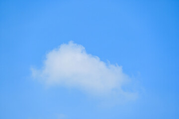 beautiful blue sky and white fluffy single cloud with sunrise in the morning, natural background