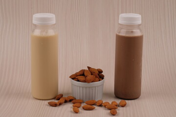 Chocolate and vanilla almond milk in a plastic bottle. made from almonds, water and sugar. suitable for vegetarians and vegans as well as people who are allergic to cow's milk. susu almond vanila. 