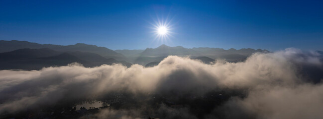 Panoramic sunrise above the cloud and misty mountain at the viewpoint of Wat Phra That Doi Kongmu...
