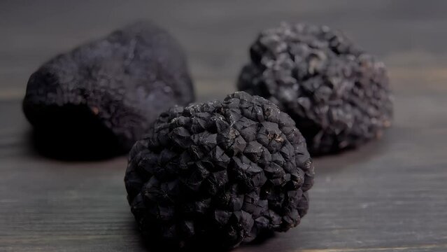 Panorama of black truffles lie on a dark surface close-up. High quality 4k footage