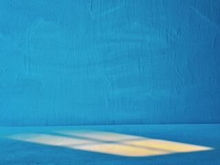 Obraz premium Blue Wall with Diagonal Shadow and Textured Surface