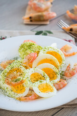 boiled eggs with boiled shrimp in a plate for breakfast