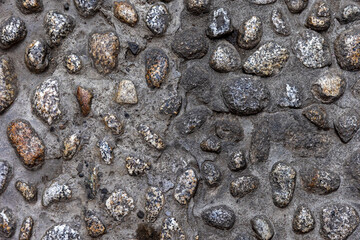 Stone background. Texture of stones. Fragment of a stone road.