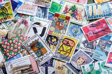 Fototapeta na wymiar Ukraine, Kiyiv - January 12, 2023.Postage stamps.A collection of world stamps in a pile.Postage stamps from different countries and times