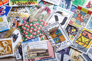 Ukraine, Kiyiv - January 12, 2023.Postage stamps.A collection of world stamps in a pile.Postage stamps from different countries and times - obrazy, fototapety, plakaty